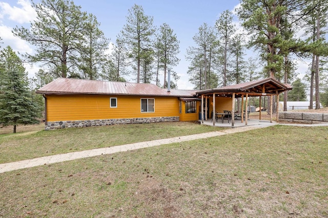 22773 Sunnyside Gulch Rd, Silver City, SD 57702 - back of house featuring a lawn, an attached carport, a patio area, and metal roof