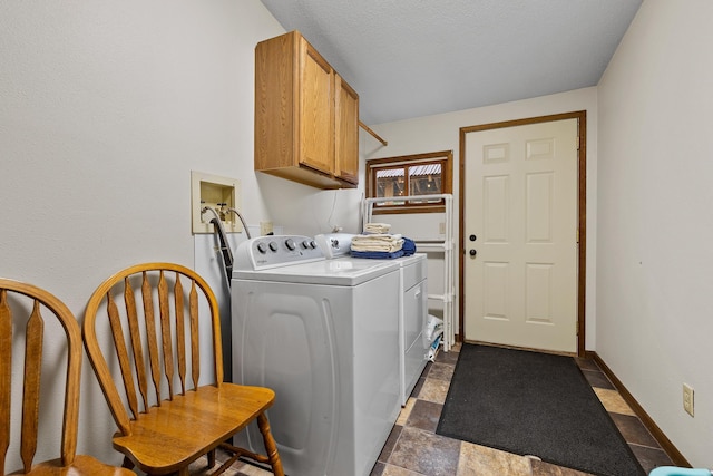 22773 Sunnyside Gulch Rd, Silver City, SD 57702 - clothes washing area with baseboards, stone finish flooring, cabinet space, and washing machine and clothes dryer