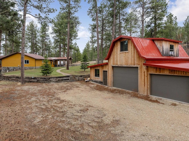 22773 Sunnyside Gulch Rd, Silver City, SD 57702 - view of side of property featuring a barn, a gambrel roof, a garage, dirt driveway, and metal roof