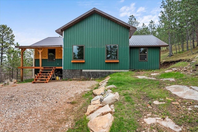 12021 Crook City Rd, Whitewood, SD 57793 - view of side of property with stairs, board and batten siding, and metal roof