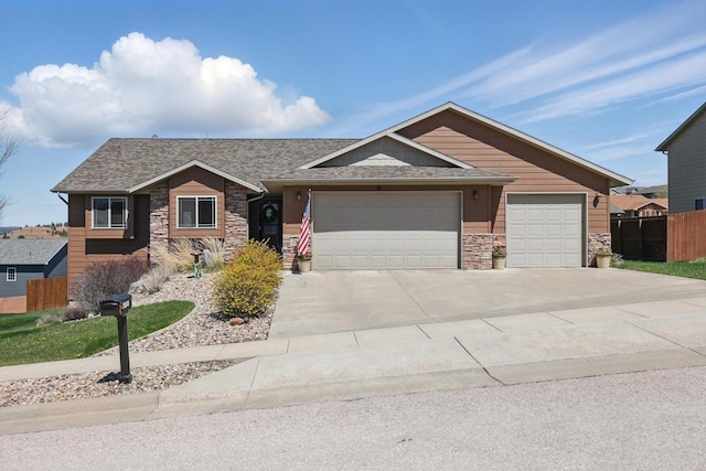 2940 Motherlode Dr, Rapid City, SD 57702 - single story home featuring roof with shingles, fence, an attached garage, stone siding, and driveway