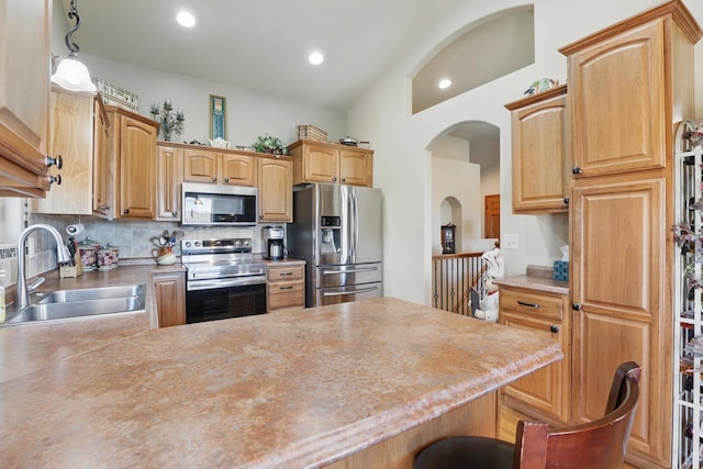 2940 Motherlode Dr, Rapid City, SD 57702 - kitchen with a peninsula, a sink, stainless steel appliances, light countertops, and decorative backsplash