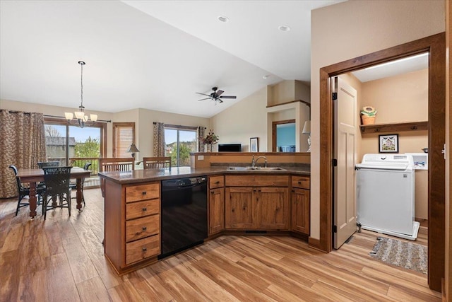 kitchen with a sink, washer / dryer, black dishwasher, brown cabinets, and dark countertops