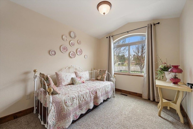 carpeted bedroom with visible vents, baseboards, and lofted ceiling