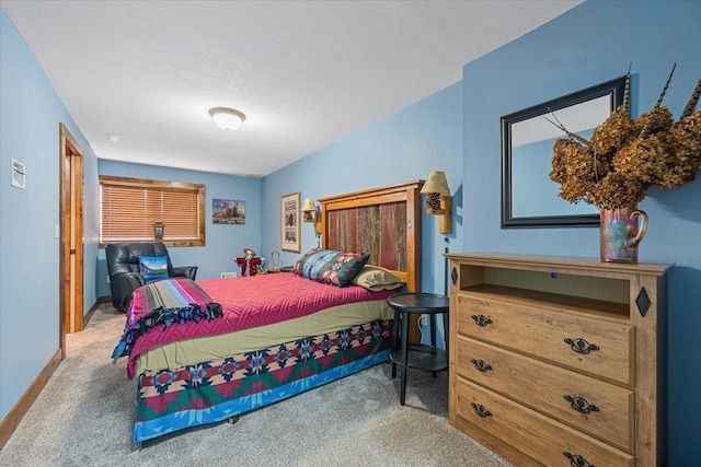 carpeted bedroom with a textured ceiling and baseboards