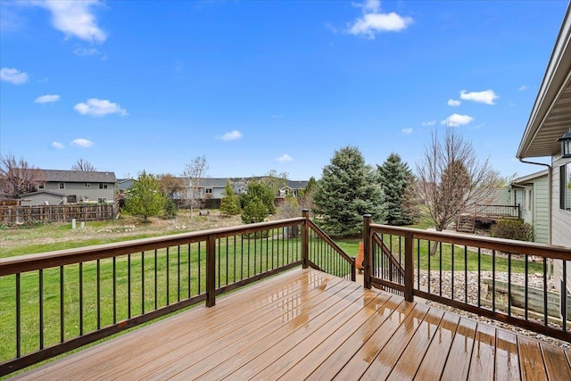 wooden deck with a yard and a residential view