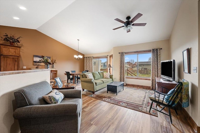 living area with wood finished floors, ceiling fan with notable chandelier, baseboards, vaulted ceiling, and recessed lighting