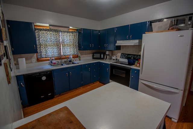 2608 Maple Ave, Rapid City, SD 57701 - kitchen with under cabinet range hood, blue cabinetry, a sink, and black appliances