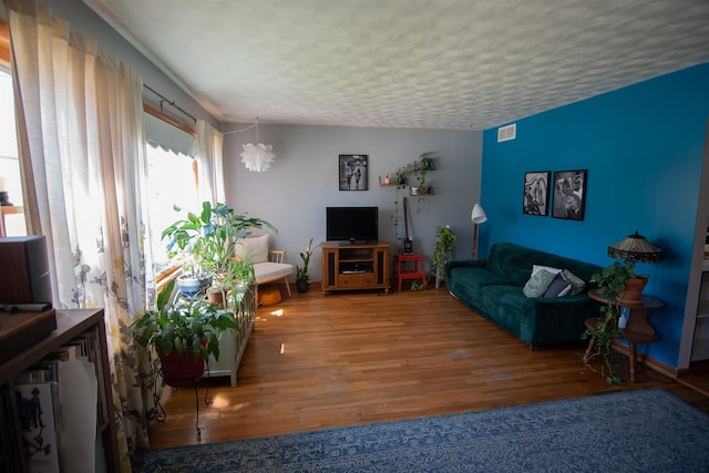 2608 Maple Ave, Rapid City, SD 57701 - living area featuring a textured ceiling, visible vents, and wood finished floors