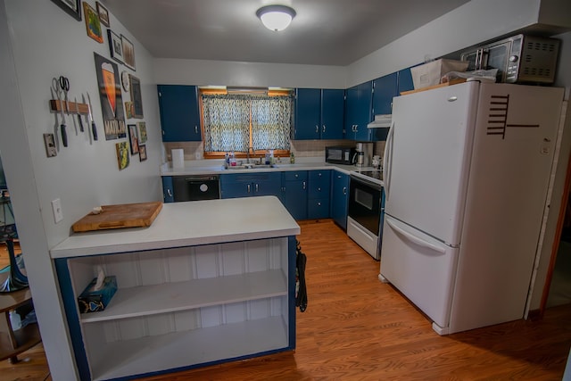 2608 Maple Ave, Rapid City, SD 57701 - kitchen with black appliances, light countertops, a sink, and blue cabinetry