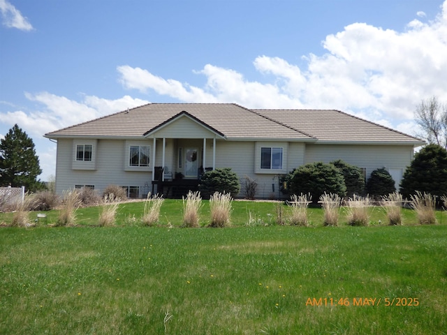 ranch-style house featuring a front yard and a tiled roof