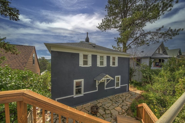 back of house with stucco siding