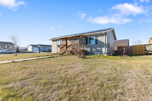 manufactured / mobile home with a front yard and fence