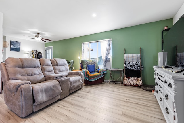living area featuring light wood-style flooring and ceiling fan