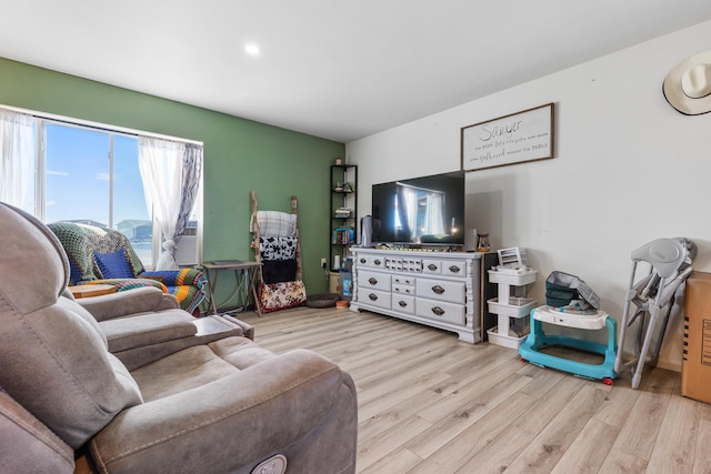 living area featuring wood finished floors and recessed lighting