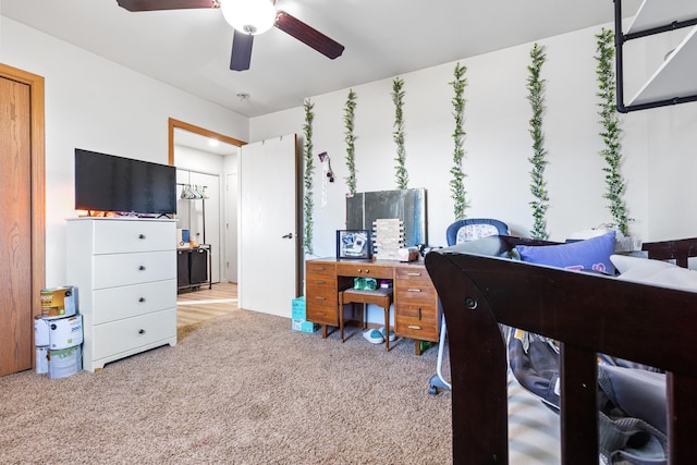 bedroom with a ceiling fan and carpet