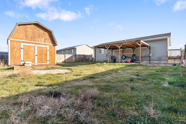 exterior space with an outdoor structure, a shed, fence, and a carport