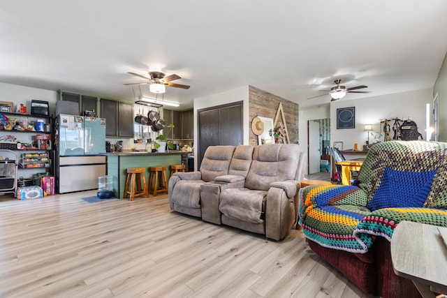 living area featuring ceiling fan and light wood-style flooring