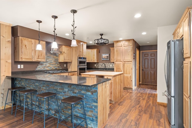 1245 Pine Cone Ln, Rapid City, SD 57701 - kitchen featuring stainless steel appliances, wall chimney exhaust hood, a peninsula, dark wood-type flooring, and recessed lighting