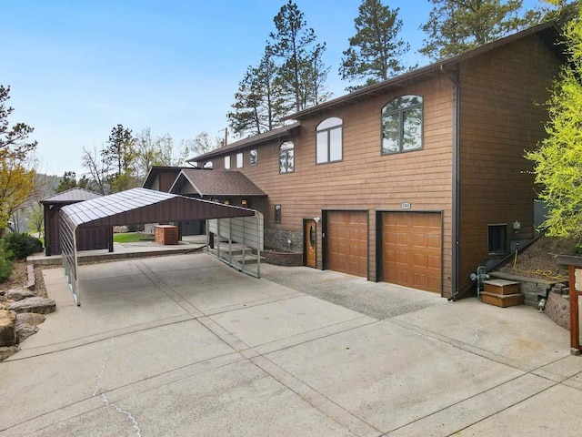 1245 Pine Cone Ln, Rapid City, SD 57701 - view of front of property with an attached garage, concrete driveway, and a carport
