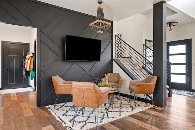 living room with wood finished floors and a decorative wall