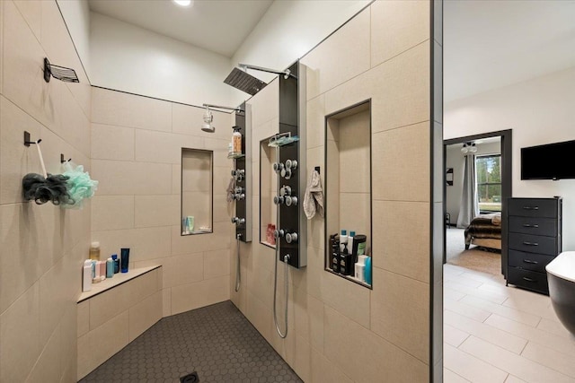 ensuite bathroom featuring a walk in shower and tile patterned floors