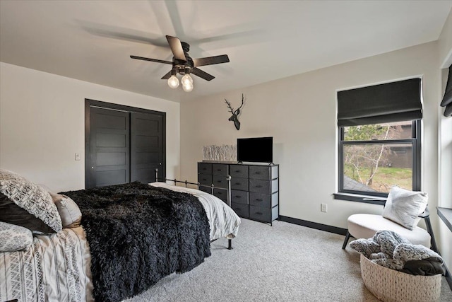 carpeted bedroom featuring baseboards, a ceiling fan, and a closet
