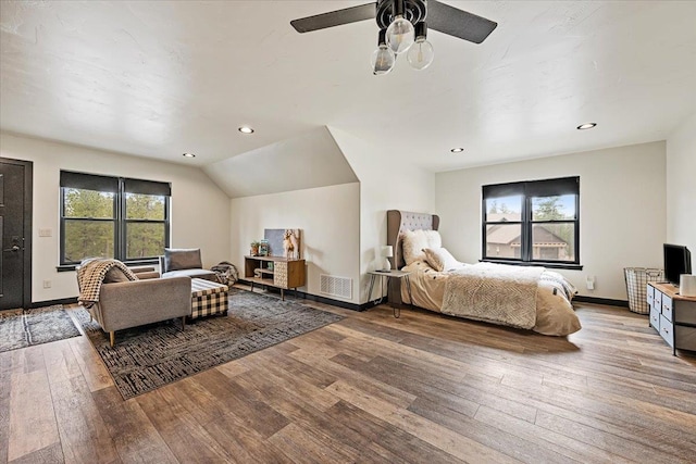 bedroom featuring hardwood / wood-style floors, baseboards, recessed lighting, a ceiling fan, and vaulted ceiling