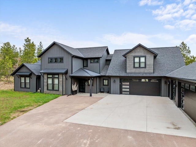 view of front of house featuring driveway, board and batten siding, a front lawn, a shingled roof, and an attached garage
