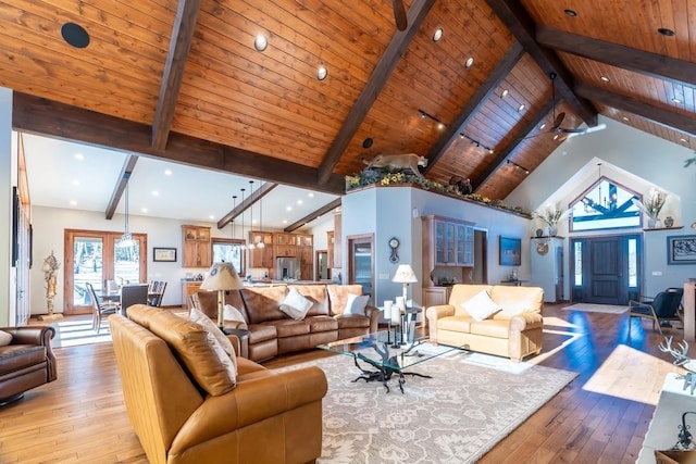 living room featuring light wood-style flooring, beamed ceiling, high vaulted ceiling, recessed lighting, and wood ceiling