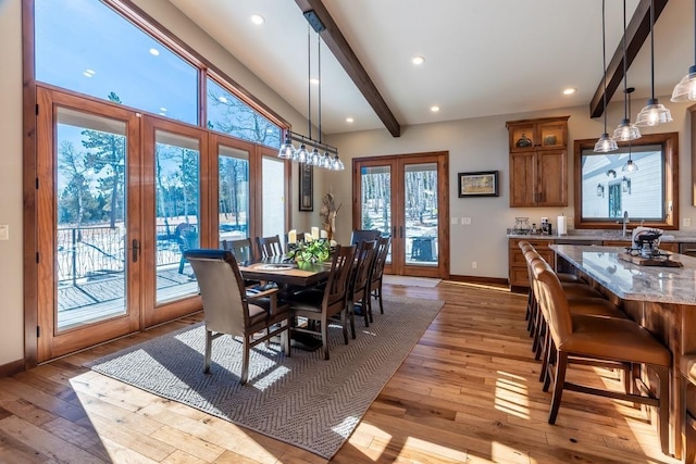 dining area with french doors, beamed ceiling, light wood-style flooring, baseboards, and recessed lighting