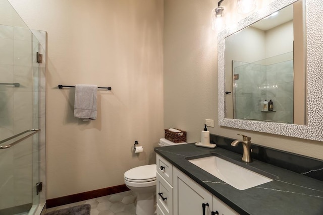 bathroom with a stall shower, toilet, and vanity