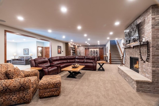 carpeted living area with recessed lighting and a brick fireplace