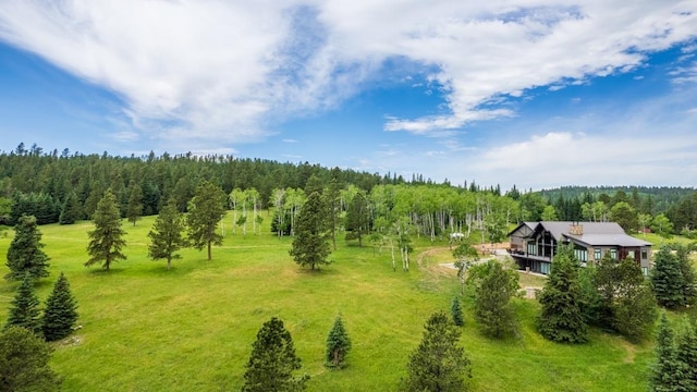 aerial view of property and surrounding area with a forest