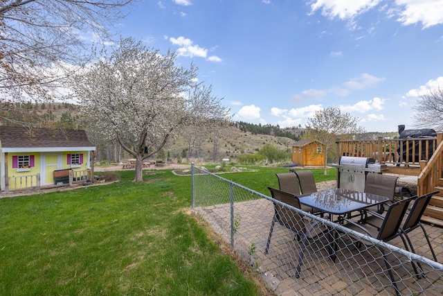 6494 Blake Rd, Rapid City, SD 57702 - view of green lawn with outdoor dining area, an outbuilding, a patio area, and a storage shed