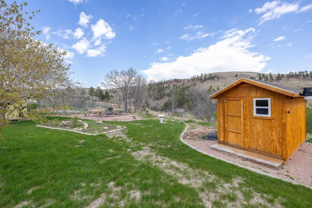 6494 Blake Rd, Rapid City, SD 57702 - view of green lawn featuring a mountain view, a storage unit, and an outdoor structure