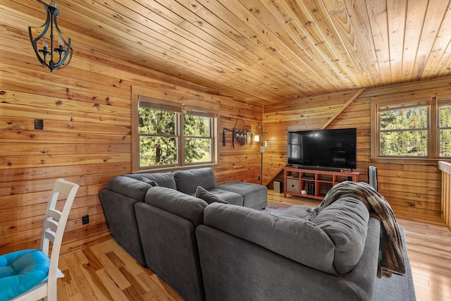 living area featuring wooden ceiling, wooden walls, and light wood-style flooring