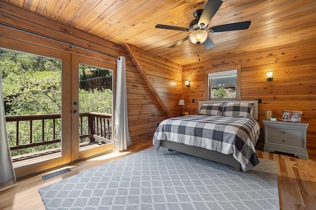 bedroom with access to outside, wood ceiling, wooden walls, light wood finished floors, and ceiling fan