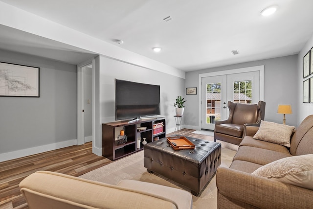 living area featuring french doors, wood finished floors, baseboards, and recessed lighting