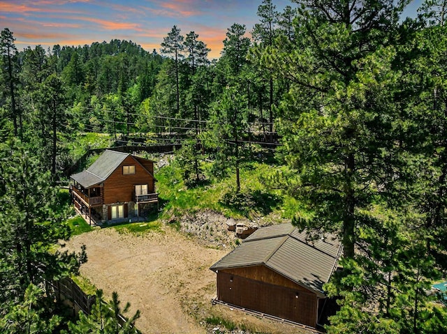 view from above of property featuring a heavily wooded area