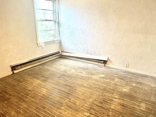 unfurnished room featuring hardwood / wood-style floors, baseboard heating, a baseboard radiator, and baseboards