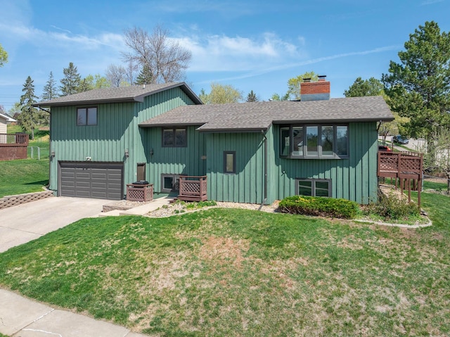 4202 Mary Dr, Rapid City, SD 57702 - view of front facade with roof with shingles, a chimney, concrete driveway, a front yard, and an attached garage