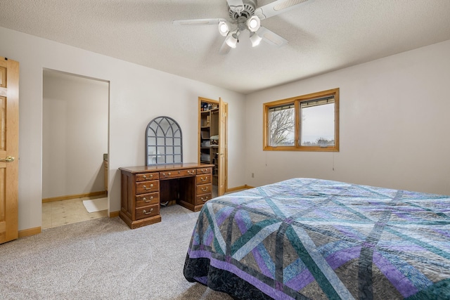 4202 Mary Dr, Rapid City, SD 57702 - bedroom featuring light carpet, ceiling fan, a textured ceiling, a walk in closet, and baseboards