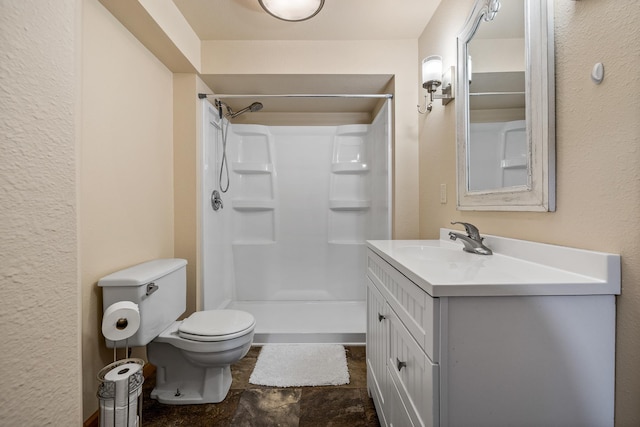 4202 Mary Dr, Rapid City, SD 57702 - full bath with a stall shower, toilet, vanity, and stone finish flooring