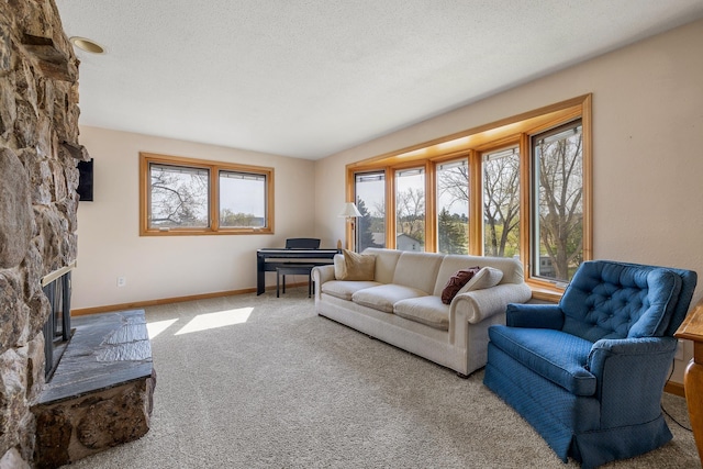 4202 Mary Dr, Rapid City, SD 57702 - carpeted living area with a stone fireplace and baseboards