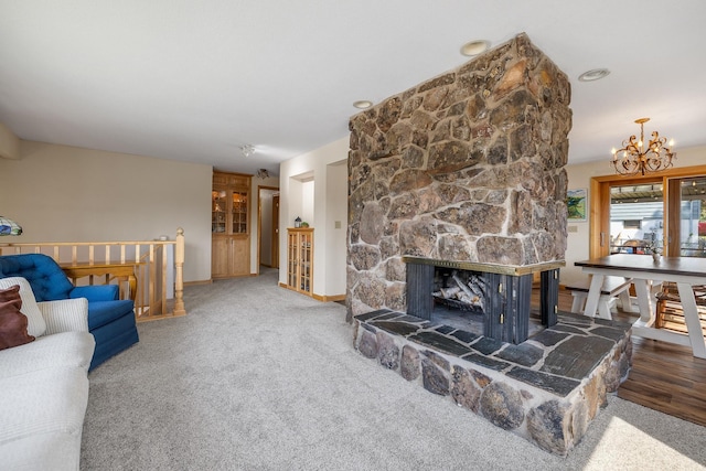 4202 Mary Dr, Rapid City, SD 57702 - living room with a chandelier, baseboards, a fireplace, and carpet flooring