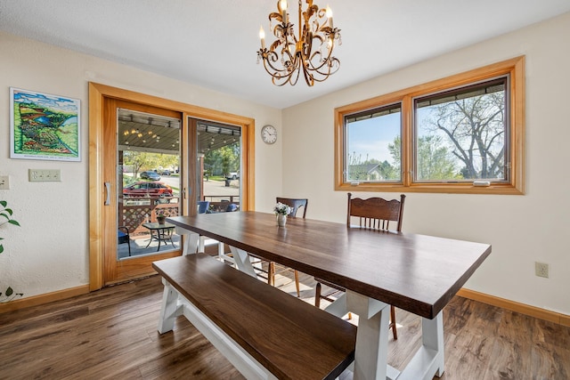 4202 Mary Dr, Rapid City, SD 57702 - dining room featuring baseboards, a chandelier, and dark wood-type flooring