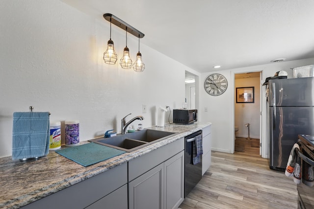 101 E Summit St, Lead, SD 57754 - kitchen featuring stainless steel appliances, a sink, light wood-style floors, decorative light fixtures, and baseboards