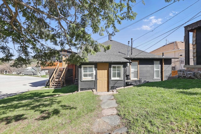 101 E Summit St, Lead, SD 57754 - bungalow-style house featuring stairway, a front lawn, and roof with shingles