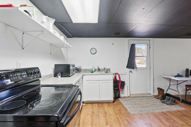 101 E Summit St, Lead, SD 57754 - kitchen featuring black appliances, light wood-style flooring, white cabinets, and open shelves